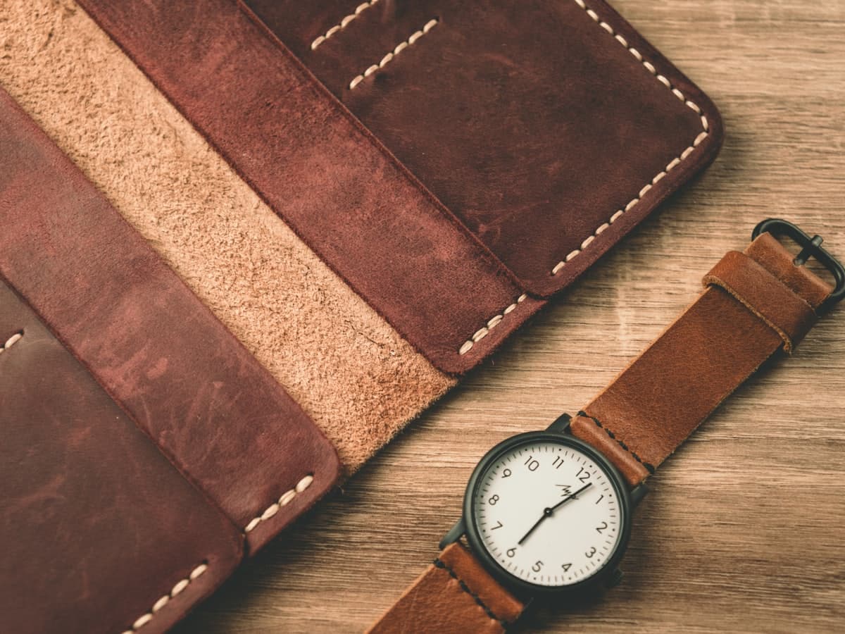 Meridian watch and wallet laid out on a desk
